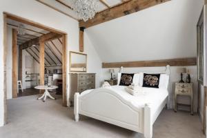 a bedroom with a white bed and a table at Maldon Executive Apartments in Maldon