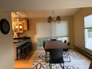 a dining room with a wooden table and chairs at The Nordic @ 1400K in Anchorage