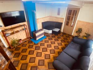 an overhead view of a living room with a couch and a tv at HOSTAL MIRAFLORES in Puerto Natales