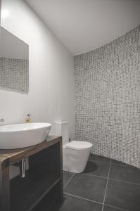 a bathroom with a white sink and a toilet at Bela Vista Silo Housing in Alfândega da Fé
