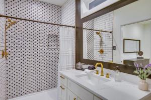 a bathroom with a tub and a sink and a mirror at Modern Kirkland Home with Private Yard and Fire Pit! in Kirkland +18 photos