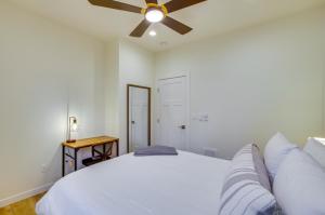 a bedroom with a white bed and a ceiling fan at Modern Vacation Rental in Kirkland with Backyard! in Kirkland