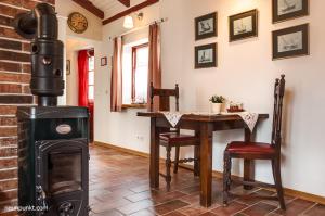 a living room with a wood stove and a table at Schlei Cottage Arnis in Sundsacker +8 photos