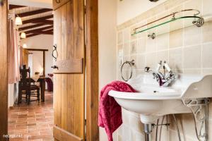 a bathroom with a white sink in a room at Schlei Cottage Arnis in Sundsacker