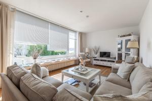 a living room with a couch and a table at Hafenblick - Kappeln in Kappeln