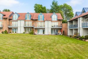 una vista exterior de un gran edificio con patio en Ellerüher Weg Maisonette, en Kappeln