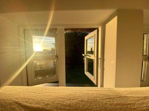 a bedroom with a bed and a window with the sunlight at Kate 4 in Stoltebüll +19 photos