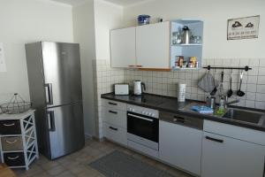 a kitchen with a refrigerator and a sink at Meer-Zeit - EG- Treibgut in Kappeln