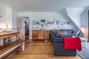 a living room with a couch and a table at Oberdeck in Maasholm +14 photos