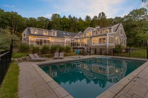 a home with a swimming pool in front of a house at The Wolfstead - near Mystic, Casinos & Beaches in Stonington