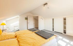 a bedroom with a bed with a yellow blanket at Ole Maisonette - OG links in Kappeln