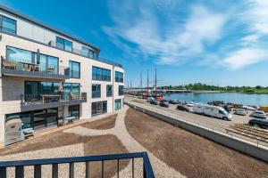 a building with a marina with cars parked next to it at Seemanns Heimat - A6 in Kappeln