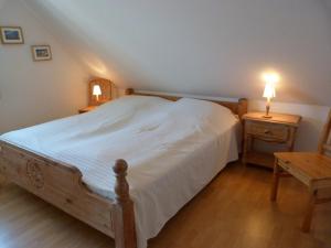 a bedroom with a bed and a table with a lamp at Schmiedekoppel in Kronsgaard