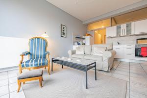 a living room with a couch and a table and a chair at Nr 14 Lotseninsel in Schönhagen