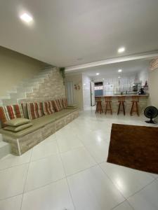 a living room with a couch and a staircase at Linda casa em Tarituba in Paraty