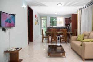 a living room with a couch and a table at The Pearl Cottages in Kampala