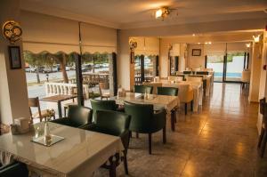 a restaurant with tables and chairs and a view of the ocean at Sun Hotel in Çeşme