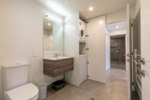 a bathroom with a toilet and a sink and a shower at Lakeside Escape in Queenstown