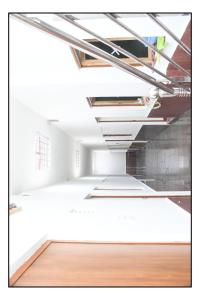 an empty room with white ceilings and a wooden floor at Bhanwar Villa Guest House in Pāl