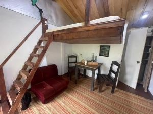 a living room with a loft bed and a table at Poas Volcano Rooms in Fraijanes