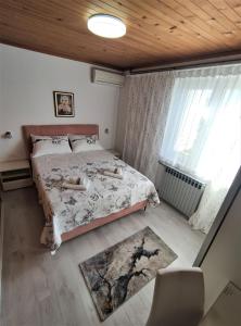 a bedroom with a bed and a window at Apartment LEMONA in Makarska