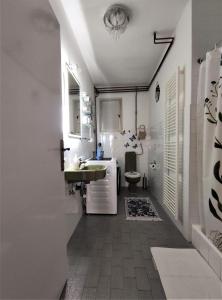 a white bathroom with a sink and a toilet at Apartment LEMONA in Makarska