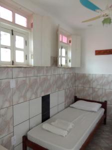 a bed in a room with two mirrors at Chapadão Hostel in Lençóis