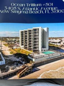 un poster per un nuovo resort balneare sull'Oceansatlantic Avenue di Coastal Condo on the beach at Ocean Trillium #501 a New Smyrna Beach
