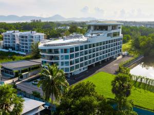 an aerial view of a building with palm trees at Sole Mio Boutique Hotel and Wellness - Adults Only in Bang Tao Beach