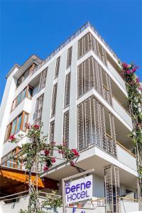 a white building with a sign in front of it at Defne Hotel in Kas