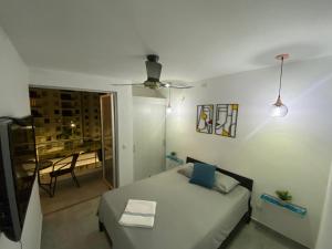 Habitación pequeña con cama y balcón. en Apto nuevo en Girardot, piscina, BBQ, terraza., en Girardot