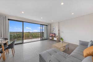 a living room with a couch and a table at Sydney Homebush Two bedroom Apartment with 2 Parkings in Sydney