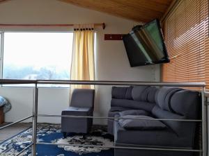 Il comprend un salon doté d'un canapé et d'une télévision à écran plat. dans l'établissement Reserva de Santa Ines, à Tibasosa