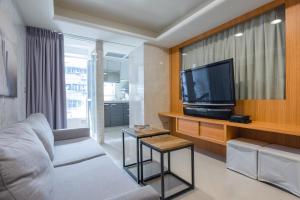 a living room with a couch and a tv at Comfy & Central 2B1b, Sleeps 5, 3min to Daan MRT 舒適市中心 2房1衛 睡5人 3分到大安站 in Taipei
