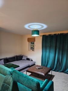 a living room with a couch and a table at Waterfront, Ethihad stadium apartments in Manchester