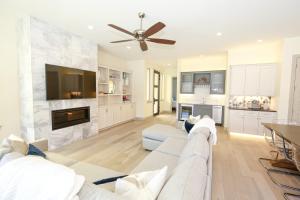 a living room with a white couch and a fireplace at Contemporary, Luxury Retreat on Lake LBJ with Heated Pool in Horseshoe Bay