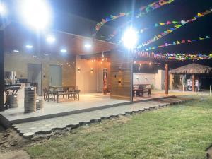 a house with a patio at night with lights at Ilha Malvinas in Paulo Afonso