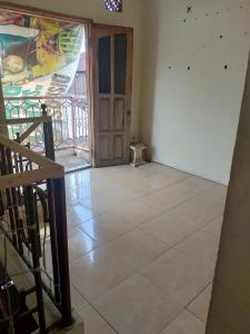 an empty room with a door and a tile floor at banyu urip kidul regency in Surabaya