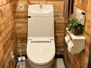 a white toilet in a bathroom with wooden walls at lineweb Home sapporo803 in Sapporo +19 photos