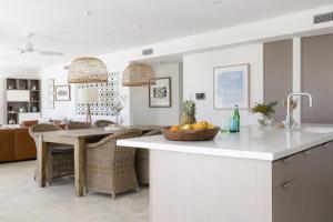 a kitchen with a island with a bowl of fruit on it at Paddle on Seven Mile in Lennox Head