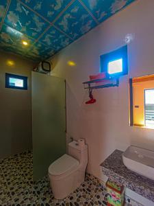 a bathroom with a toilet and a sink at YoLo Pool Bar Villas in Phong Nha