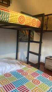 a bunk bed with a pillow on top of it at RAPSoDIA HOSTEL in Villa de Leyva