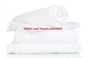 a stack of towels with the words sheets and towels provided at 6A Hough Street - pet friendly, air con, wi-fi and linen provided in Nelson Bay