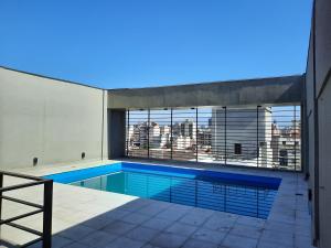 a swimming pool with a view of a city at Rouse in San Miguel de Tucumán