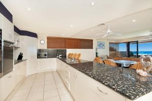 a kitchen with a counter top and a dining room at Portofino in Lennox Head