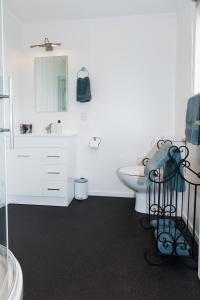 a white bathroom with a sink and a toilet at Hopwood Bed & Breakfast in Taihape