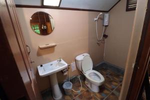 a bathroom with a toilet and a sink at Suchanaree@Laemngop in Trat