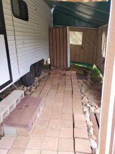 a garage with awning and steps next to a trailer at Private Caravan and facilities - Tarzali Valley Veiws in Tarzali