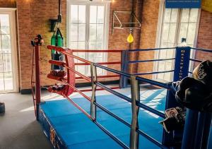 a gym with a boxing ring in a building at Pattaya Grand florida Beach 36 in Na Jomtien