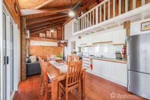 a kitchen and dining room with a table and chairs at Beachfront Holiday House in Zilzie +20 photos